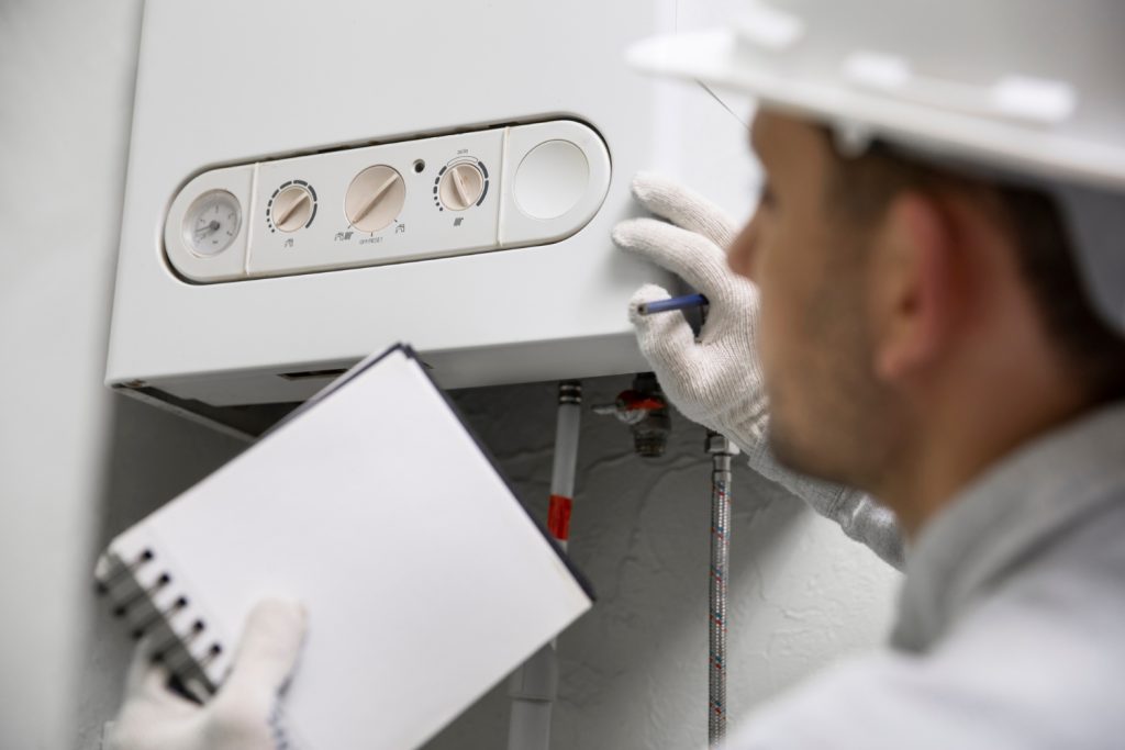 man installing a tankless water heater